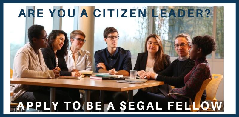 Segal Fellows Sitting Around a Table Talking with Text "Are you a citizen leader? Apply to be a Segal Fellow"